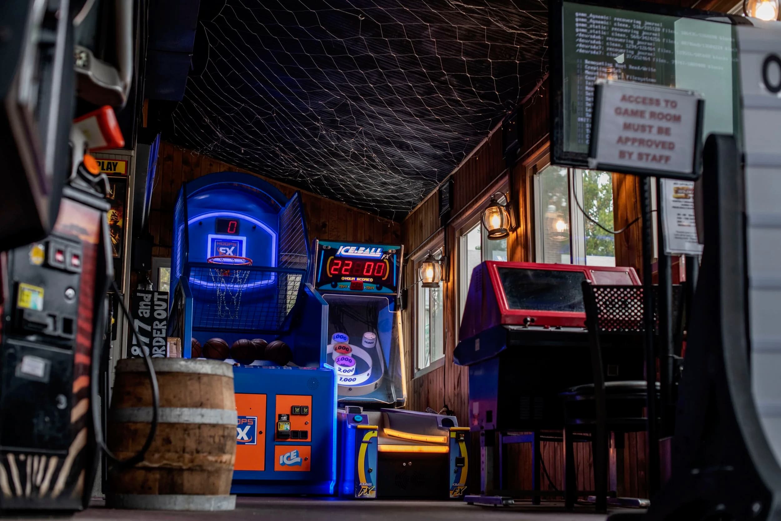 Arcade games and skeeball machines glowing in the SOHA game room