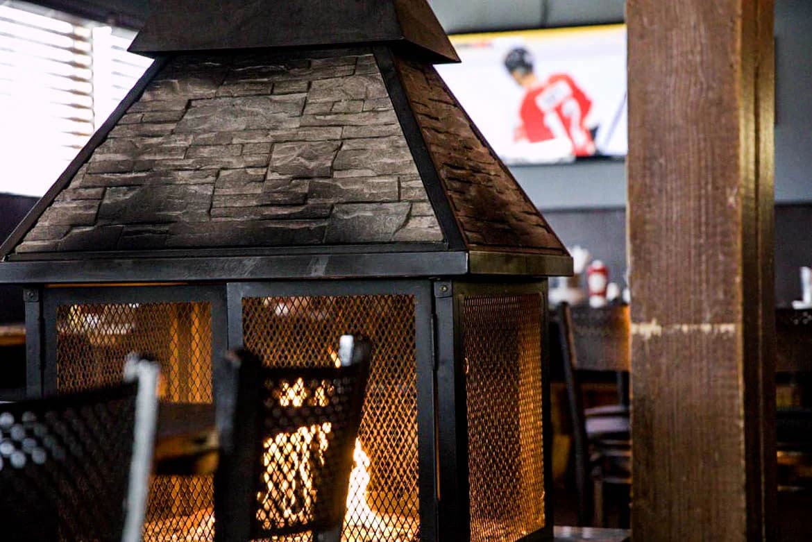 The stone fireplace among tables inside SOHA