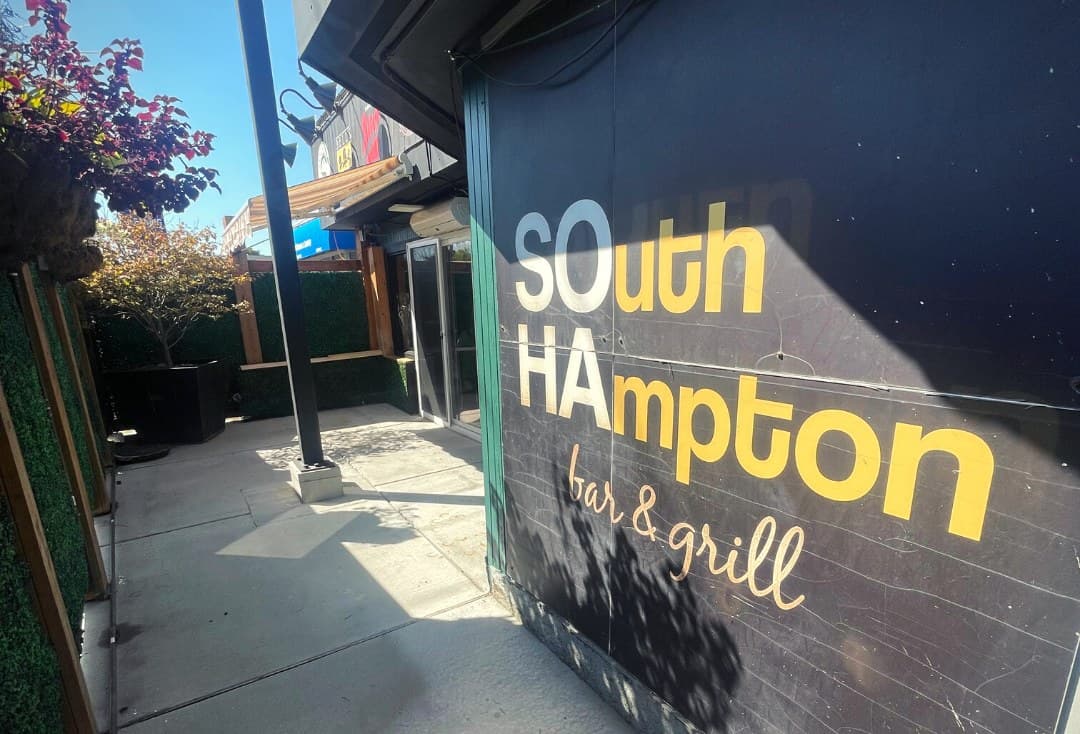 The lower patio wall painted with SOuth HAmpton bar and grill