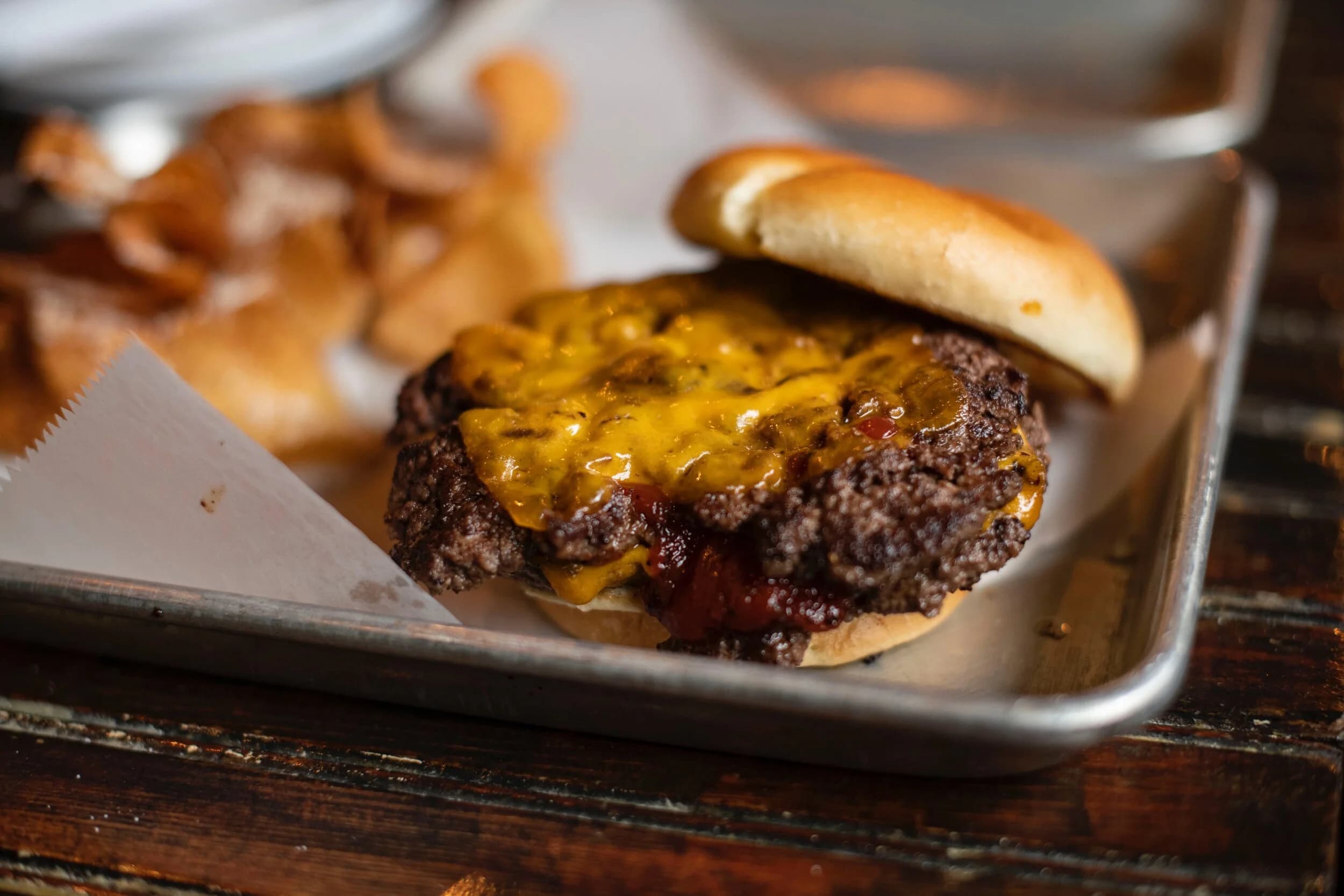 A cheeseburger and french fries on a tray